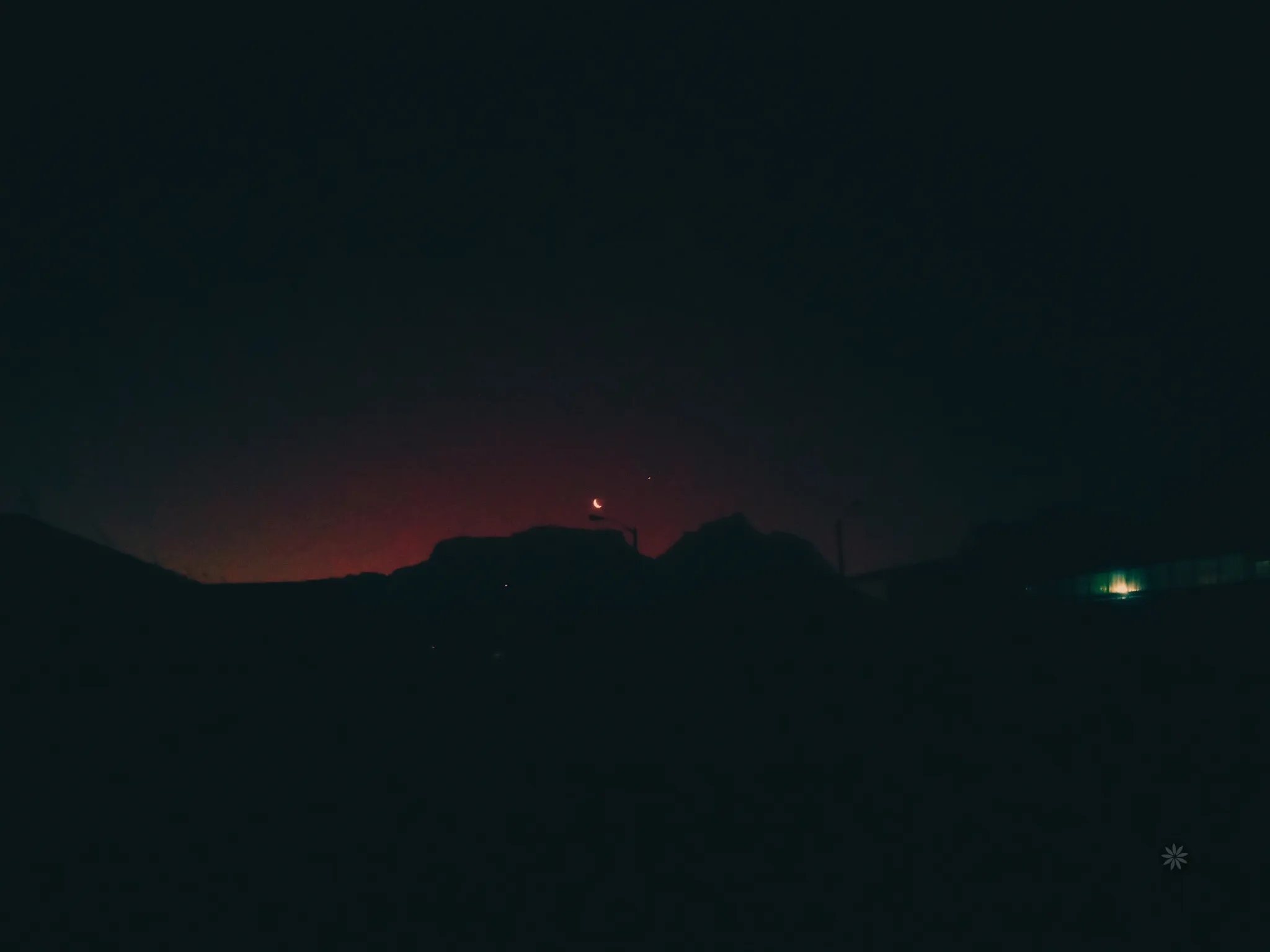 Image of table mountain during loadshedding taken from dark street in a neighbourhood